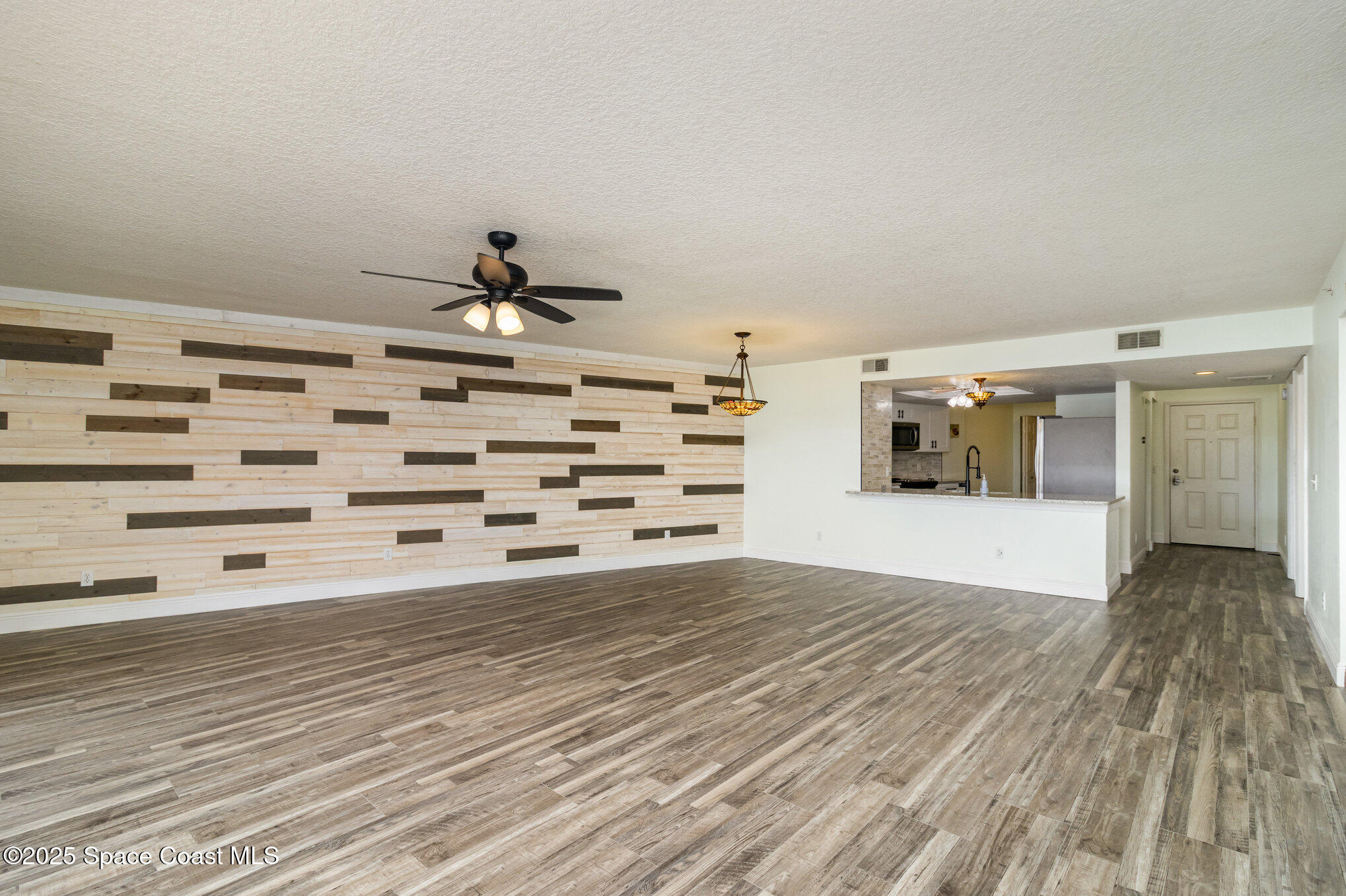 102 Riverside Drive, Unit 203 Cocoa, FL 32922 - Photo 4 of 26 a view of empty room with wooden floor