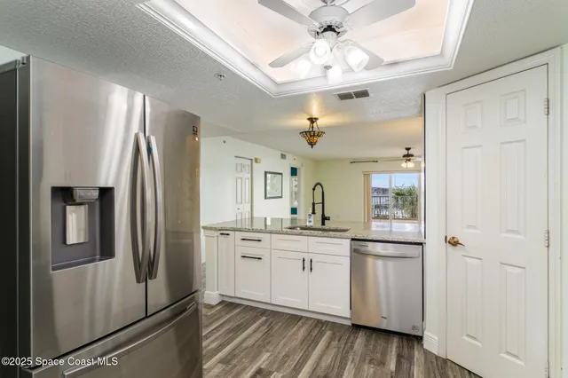 a kitchen with stainless steel appliances a refrigerator sink and microwave