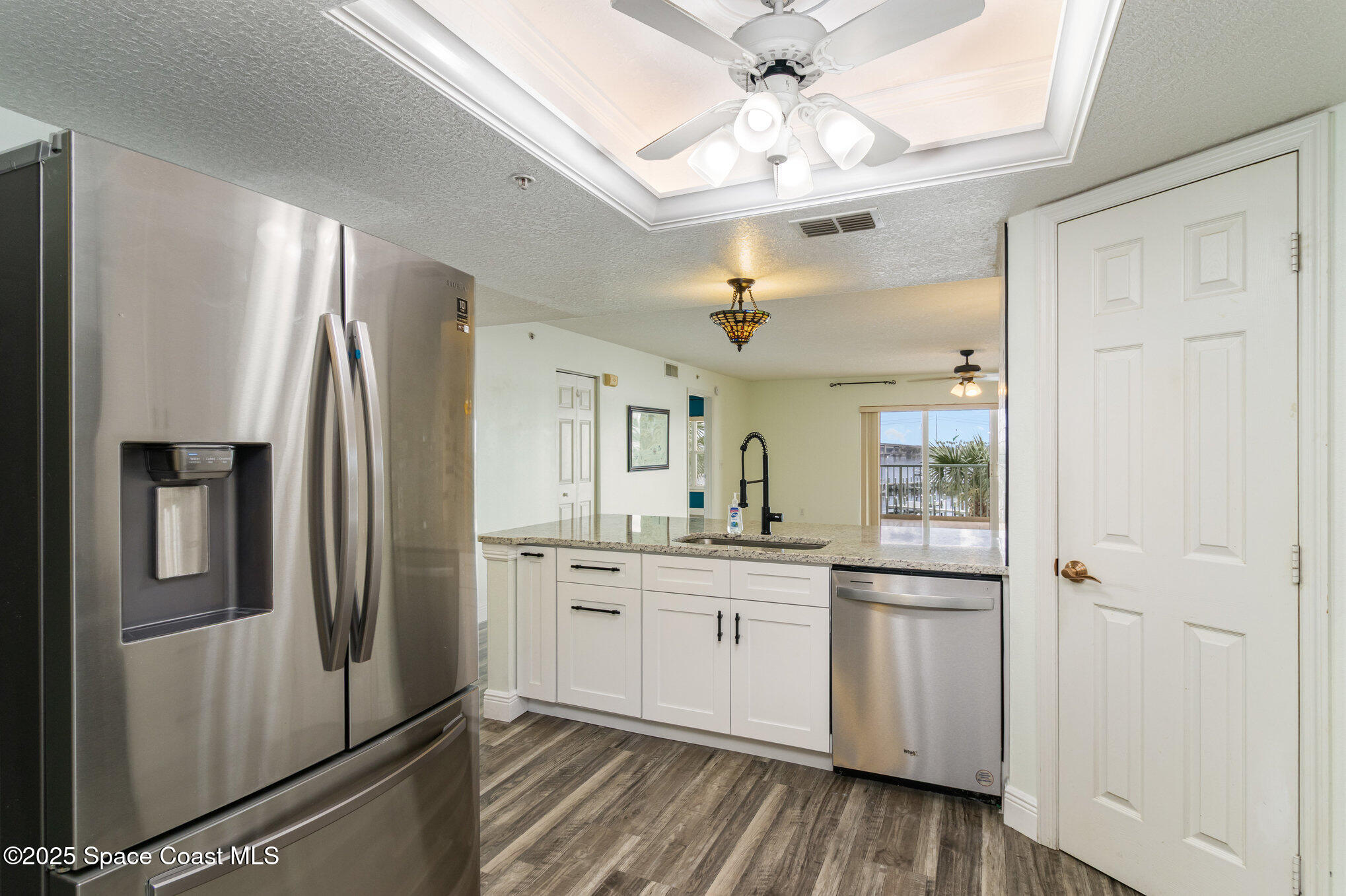 102 Riverside Drive, Unit 203 Cocoa, FL 32922 - Photo 7 of 26 a kitchen with stainless steel appliances a refrigerator sink and microwave