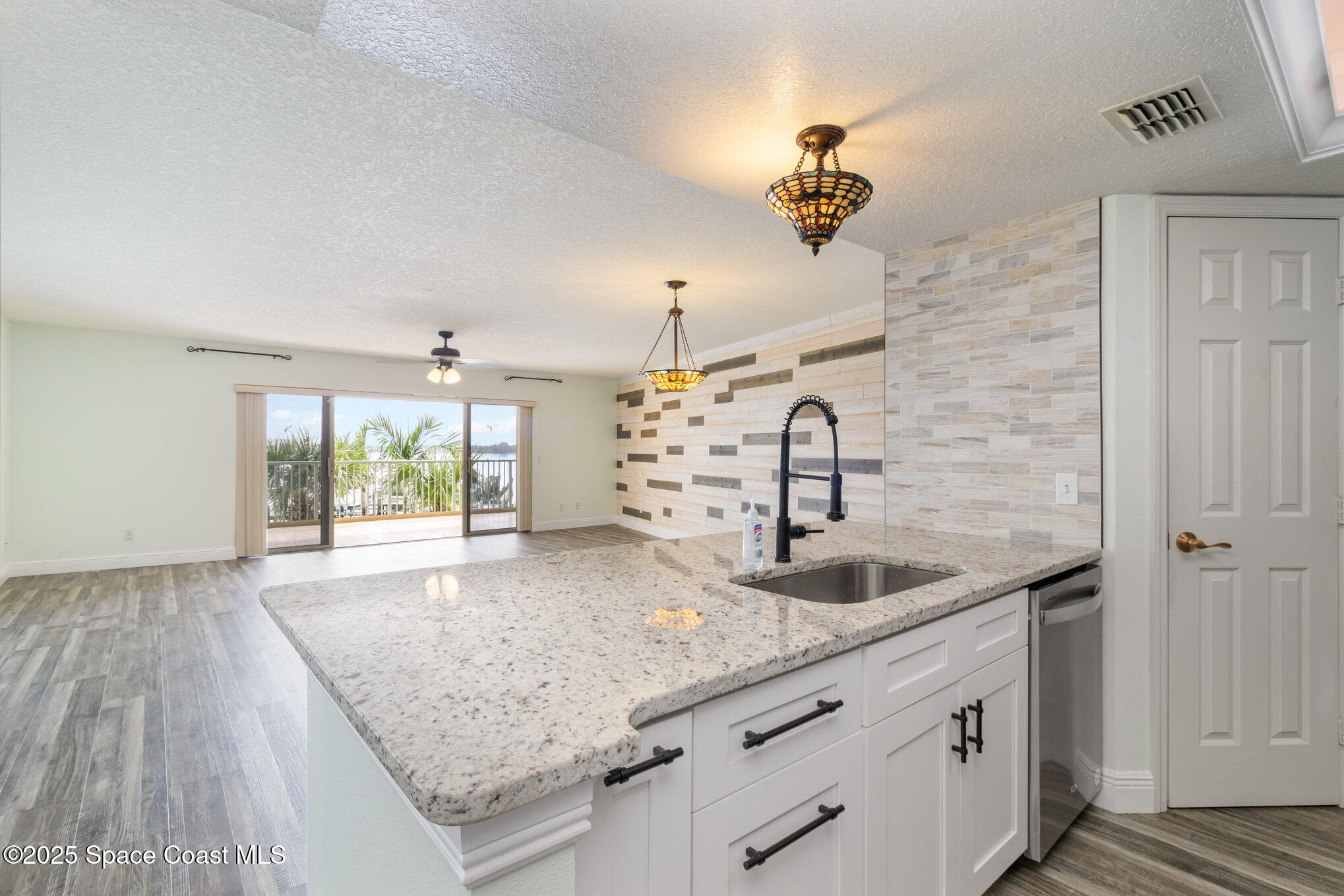 102 Riverside Drive, Unit 203 Cocoa, FL 32922 - Photo 8 of 26 a kitchen with a sink and a large mirror