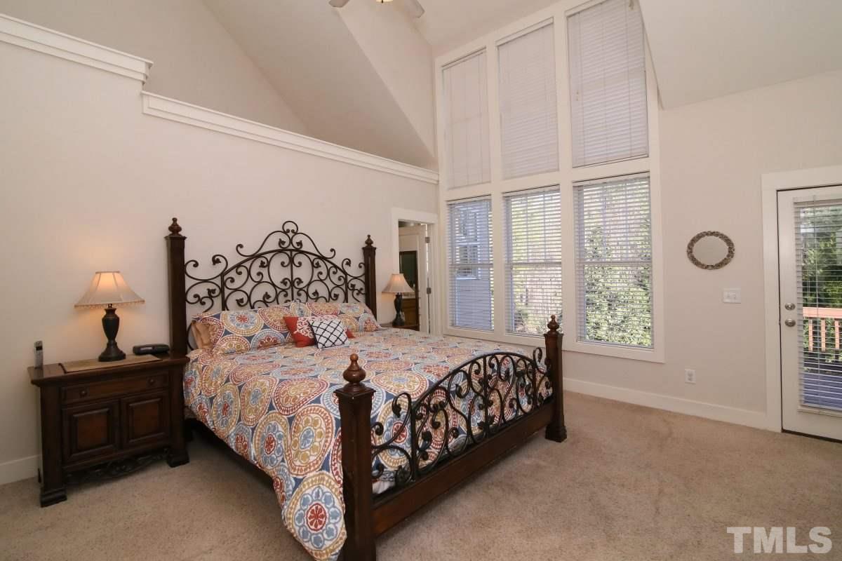 1128 Coram Fields Road Wake Forest, NC 27587 - Photo 13 of 25 This large 1st floor master has a vaulted ceiling, ceiling fan, large walk-in closet & door to the back deck!