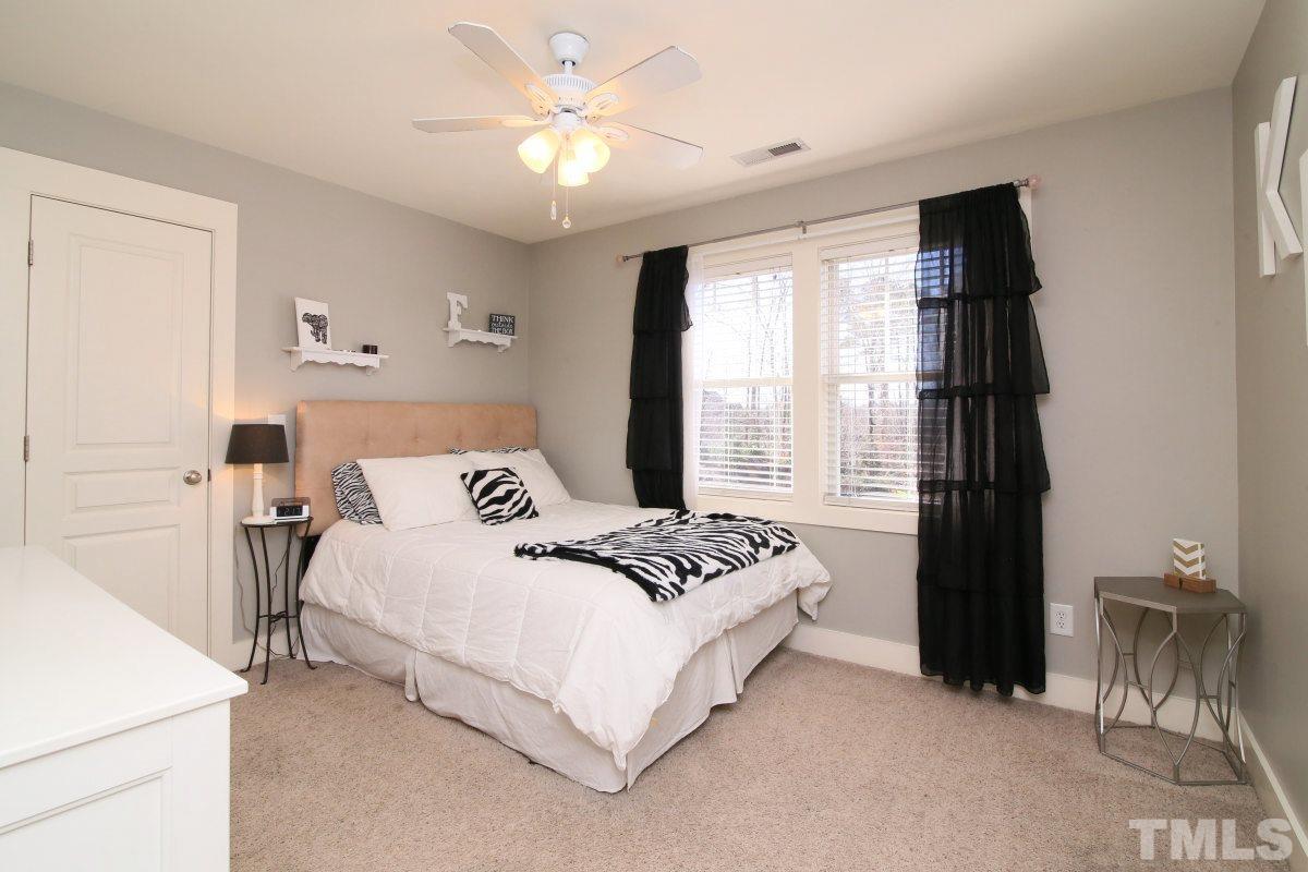 1128 Coram Fields Road Wake Forest, NC 27587 - Photo 16 of 25 Bedroom 2 features double windows, a ceiling fan and large walk-in closet!