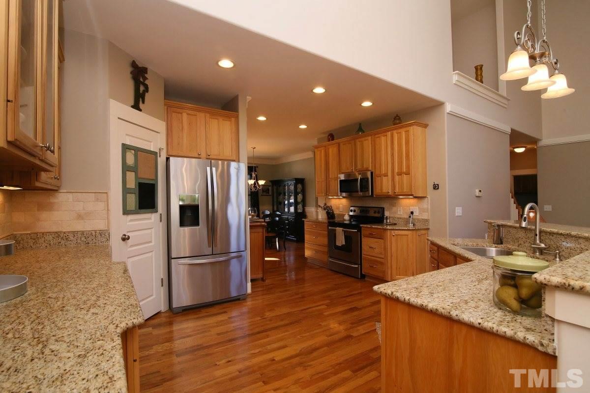 1128 Coram Fields Road Wake Forest, NC 27587 - Photo 9 of 25 The kitchen features stainless appliances, granite countertops, under cabinet lighting, a separate pantry and great cabinet space!