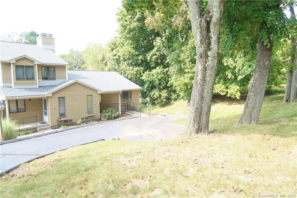 21 Ridge Road, Unit 21 Wethersfield, CT 06109 - Photo 1 of 1 a front view of a house with a yard and garage