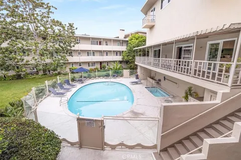 a swimming pool with outdoor seating and yard