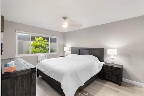 a bedroom with a large bed and a window