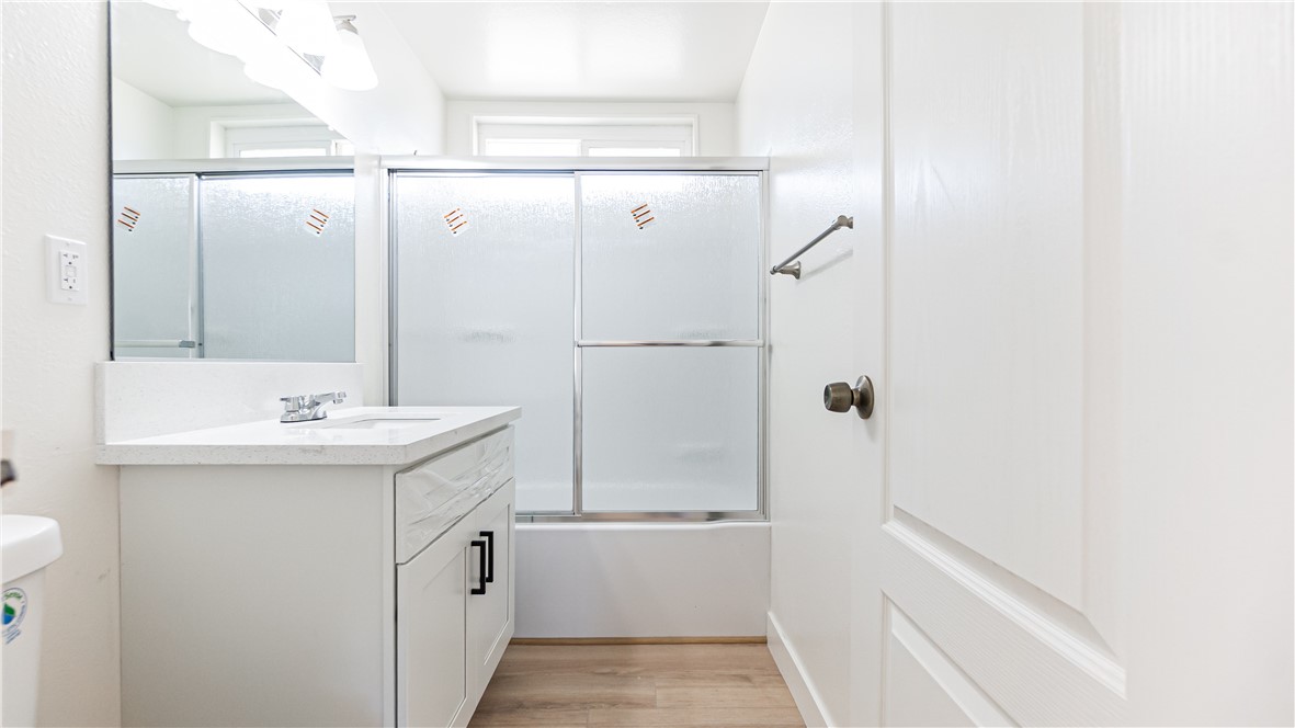 9293 Guava Avenue Hesperia, CA 92345 - Photo 12 of 32 a bathroom with a sink and mirror with bathtub