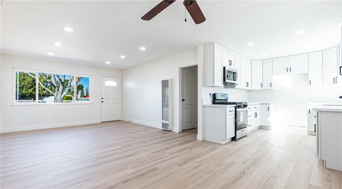 9293 Guava Avenue Hesperia, CA 92345 - Photo 3 of 32 a view of kitchen with stainless steel appliances cabinets and wooden floor