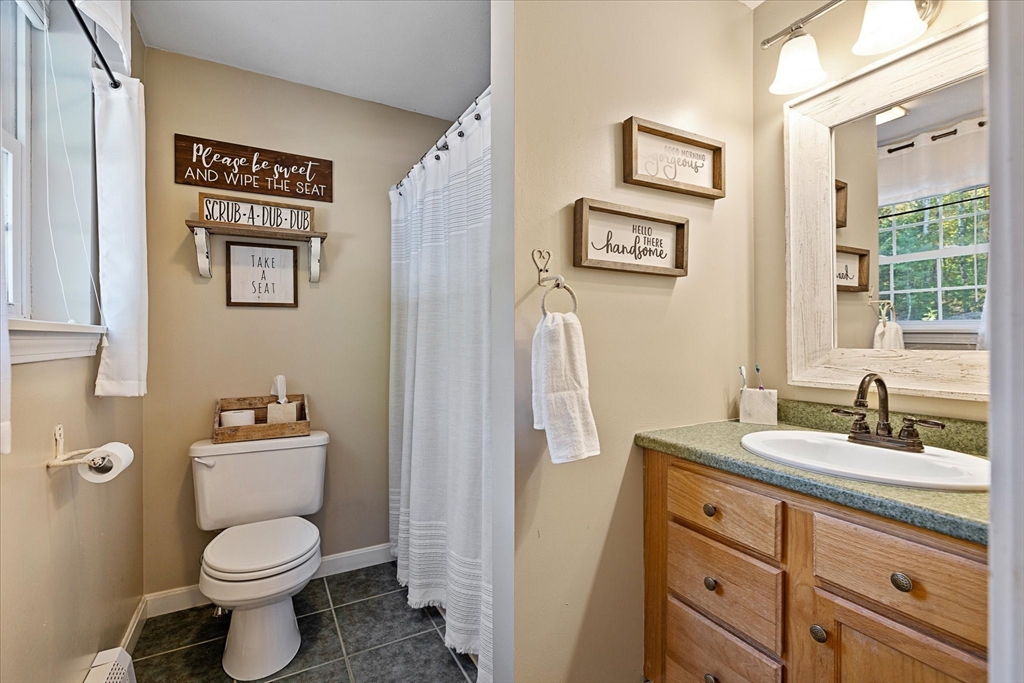 27 Ware Drive Templeton, MA 01436 - Photo 14 of 34 a bathroom with a toilet a sink and a mirror