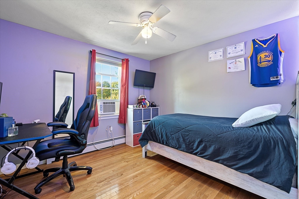 27 Ware Drive Templeton, MA 01436 - Photo 16 of 34 a bedroom with a bed and a chandelier