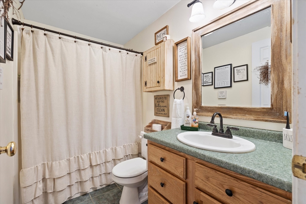 27 Ware Drive Templeton, MA 01436 - Photo 17 of 34 a bathroom with a granite countertop sink and a mirror