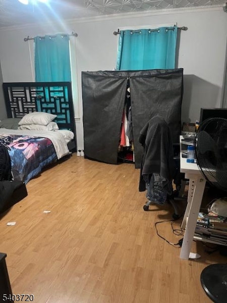 43 Patterson Street Newark, NJ 07105 - Photo 3 of 15 a bedroom with a bed and a wooden floor