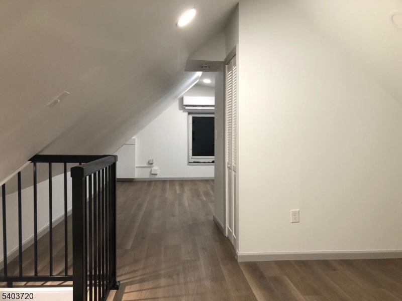 43 Patterson Street Newark, NJ 07105 - Photo 8 of 15 a view of a hallway with wooden floor and staircase