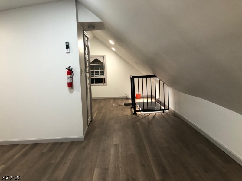 43 Patterson Street Newark, NJ 07105 - Photo 9 of 15 an empty room with wooden floor and windows