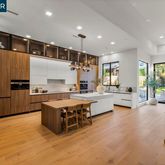 a kitchen with kitchen island a large counter top space a sink stainless steel appliances and cabinets