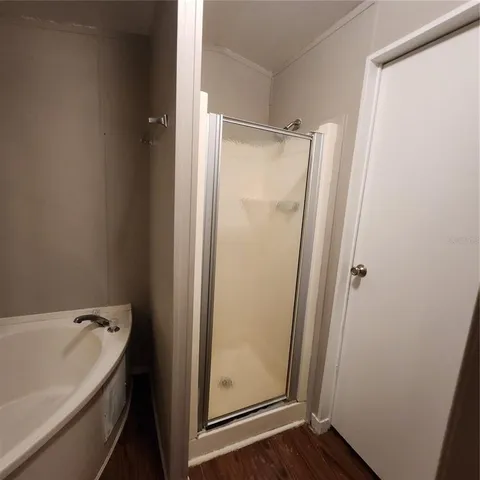 a bathroom with a bathtub and a shower