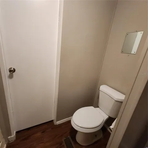 a white toilet sitting next to a shower