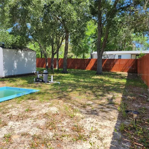 a view of a backyard with swimming pool
