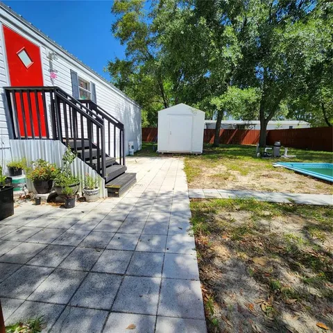 a backyard of a house with yard and outdoor seating