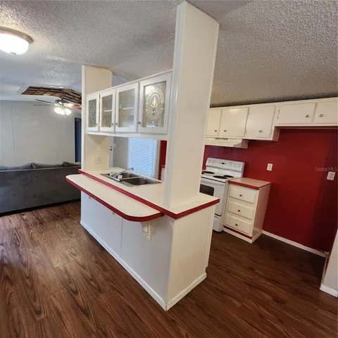 a room with wooden floor and furniture