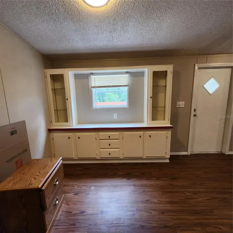 a view of room with window and wooden floor