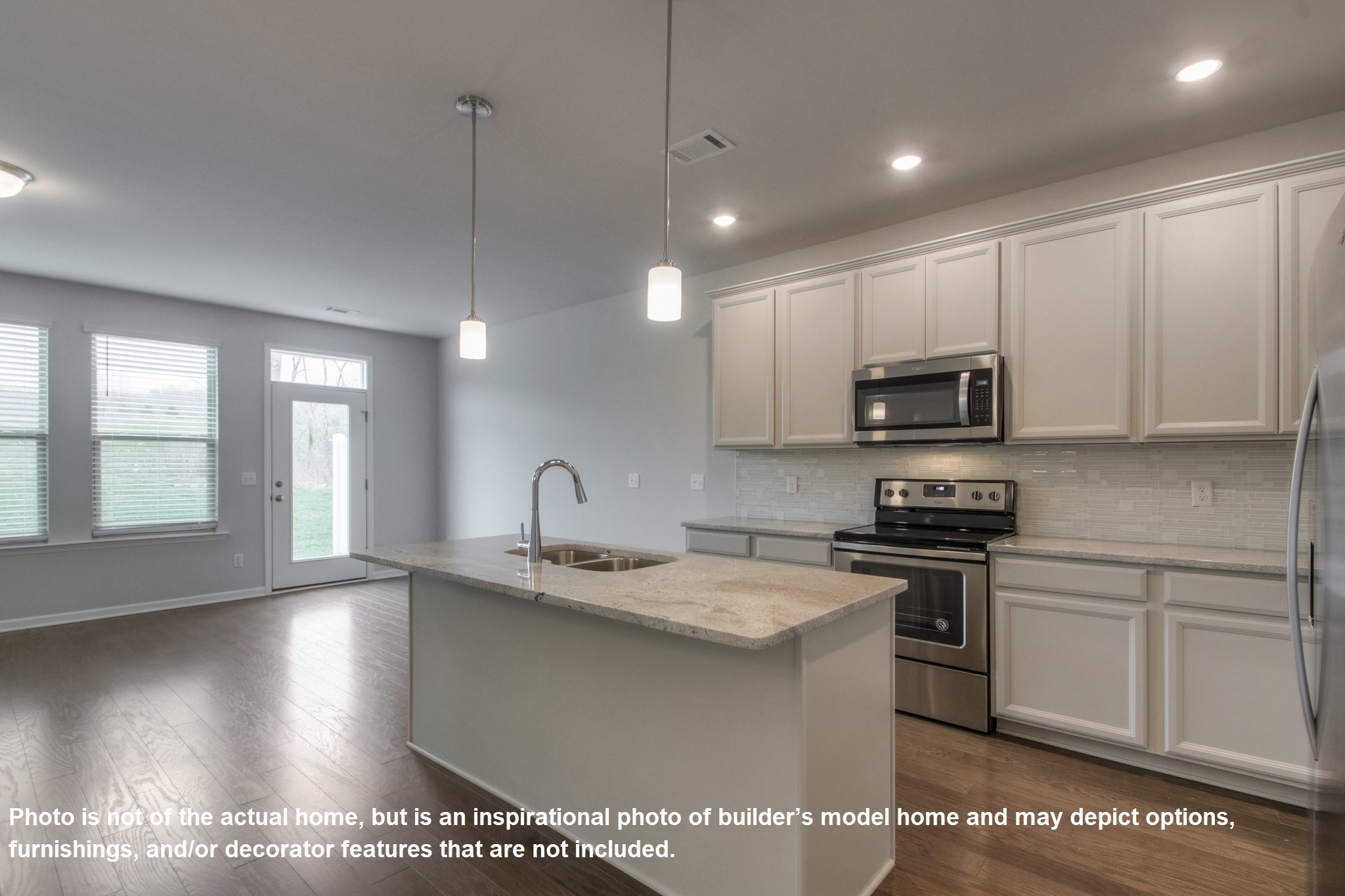 321 Cheval Drive Gallatin, TN 37066 - Photo 6 of 11 a kitchen with stainless steel appliances granite countertop a sink a stove a microwave a center island and cabinets