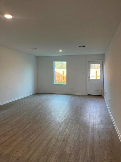 924 Pertuso Lane Huffman, TX 77336 - Photo 3 of 14 an empty room with wooden floor and windows