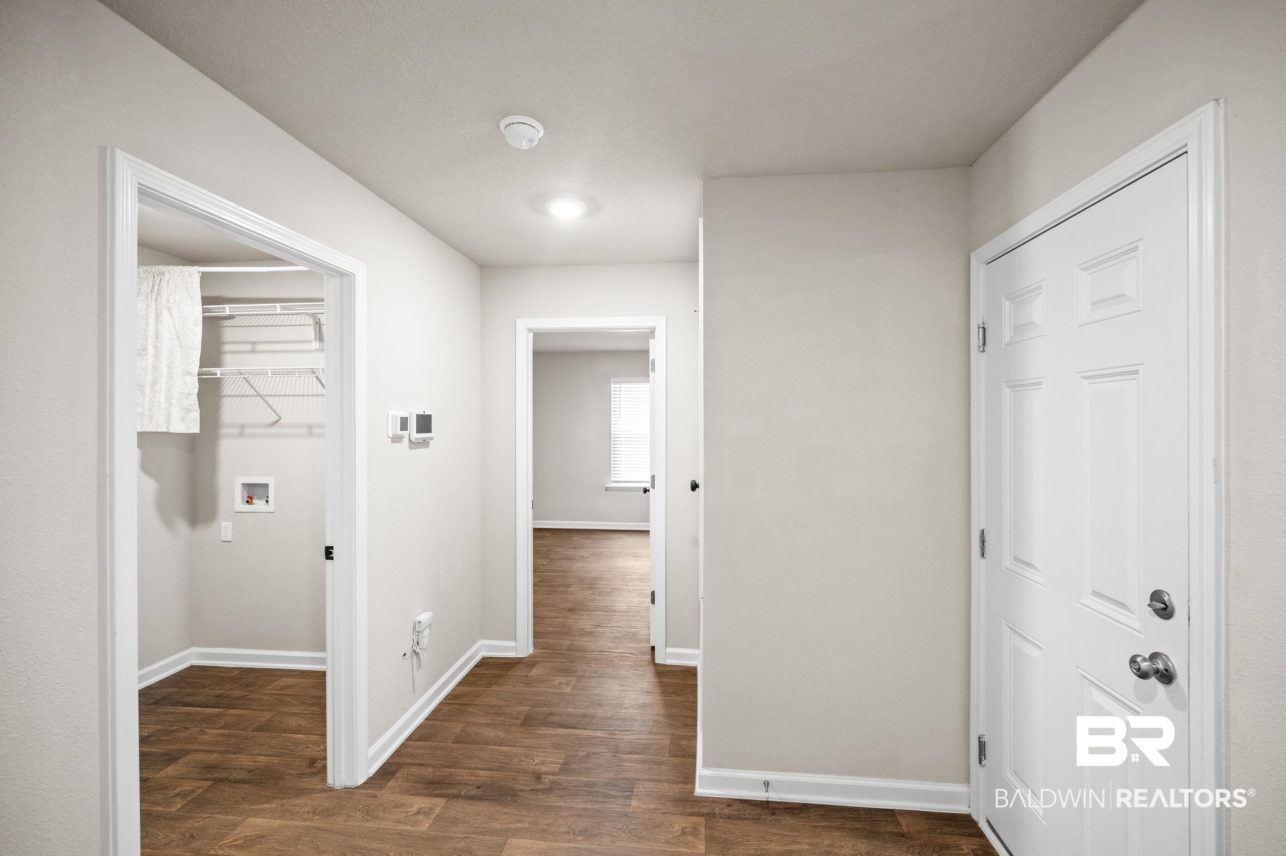 10353 Zenyatta Loop Daphne, AL 36526 - Photo 25 of 33 Hallway with dark wood-type flooring