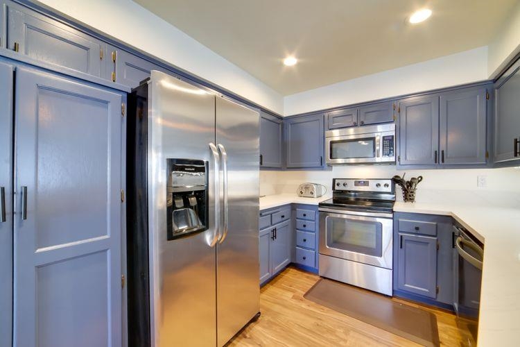 591 Golden Creek Road, Unit 591 Mammoth Lakes, CA 93546 - Photo 9 of 19 a kitchen with stainless steel appliances granite countertop a refrigerator and a stove top oven