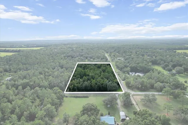 a view of a swimming pool with a yard