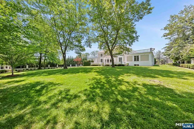 a kitchen with granite countertop a sink and white cabinets