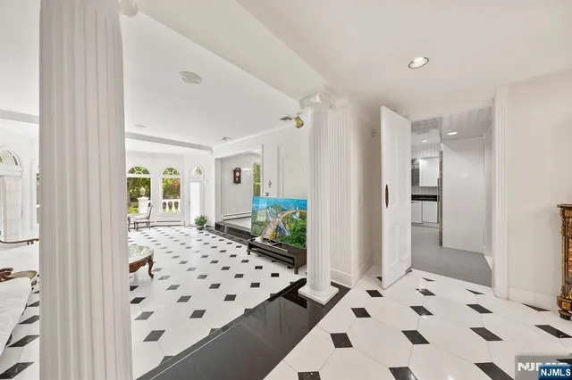 a living room with stainless steel appliances kitchen island granite countertop a couch and cabinets