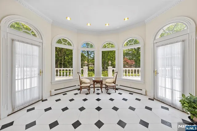 an aerial view of residential houses with outdoor space and trees