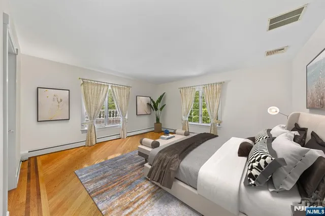 a bedroom with two beds and a large window