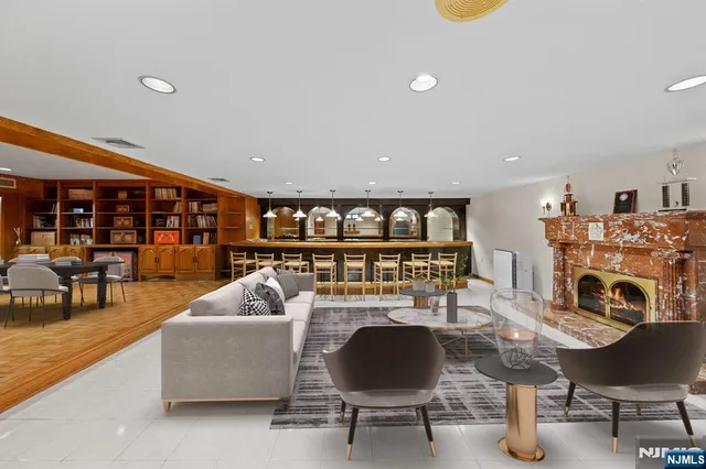 a living room with fireplace furniture and a table