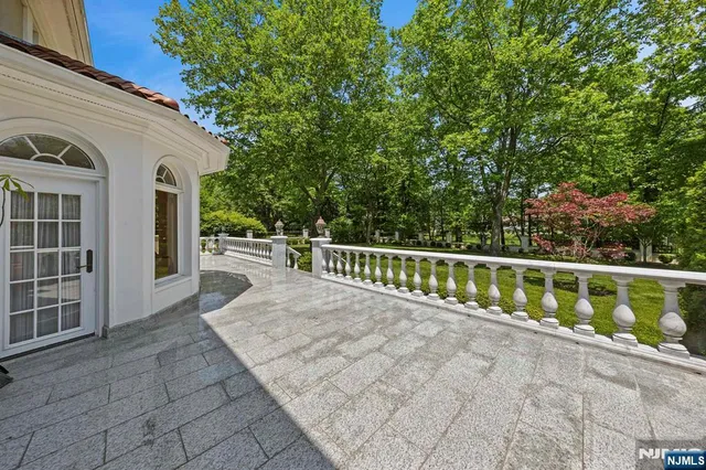 a living room with furniture a flat screen tv and a large window