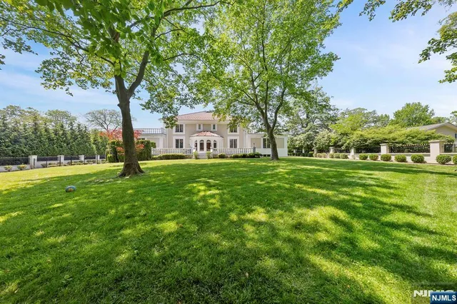 a kitchen with stainless steel appliances granite countertop a sink and a refrigerator