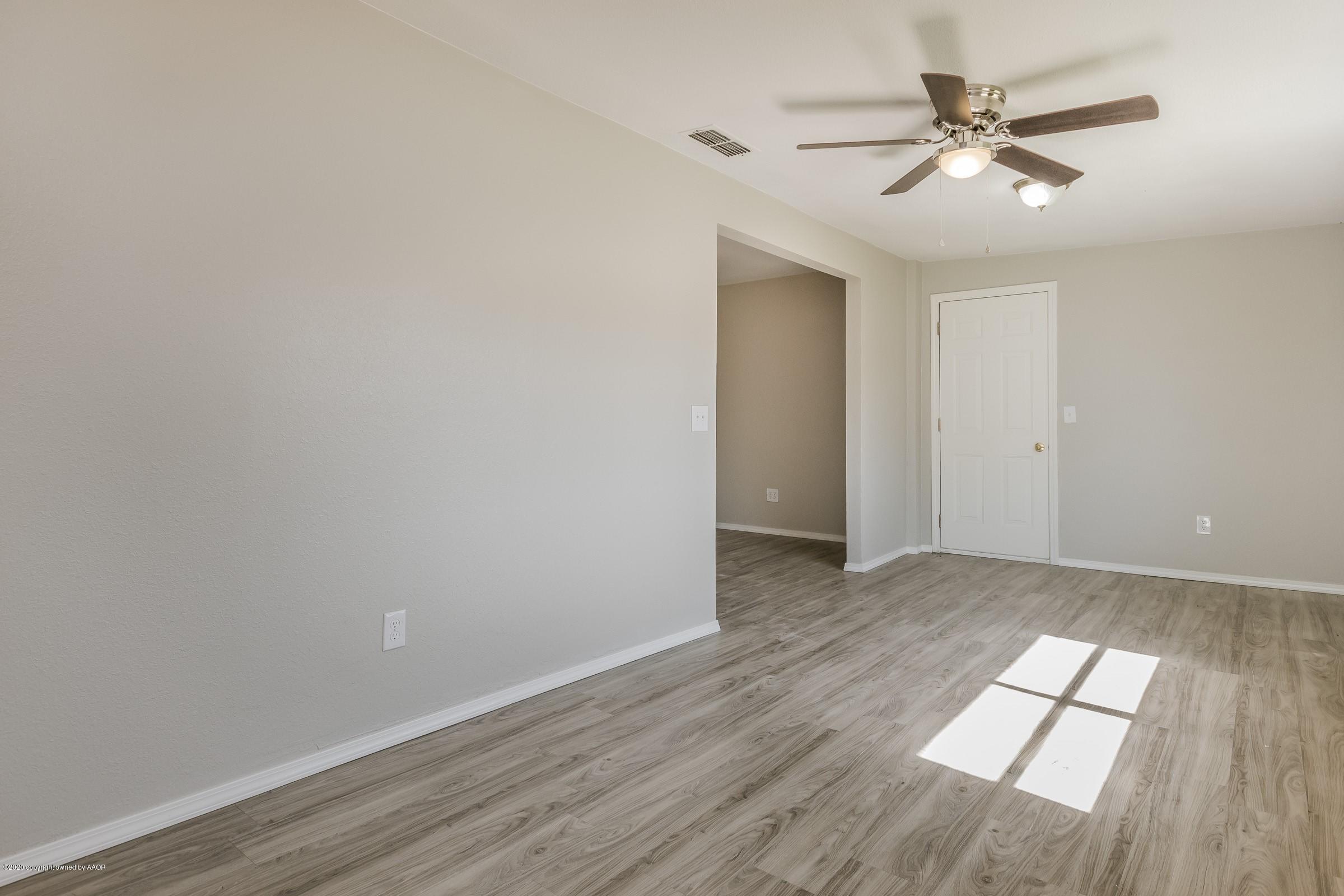 5135 Bowie Street Amarillo, TX 79110 - Photo 11 of 24 an empty room with wooden floor and windows