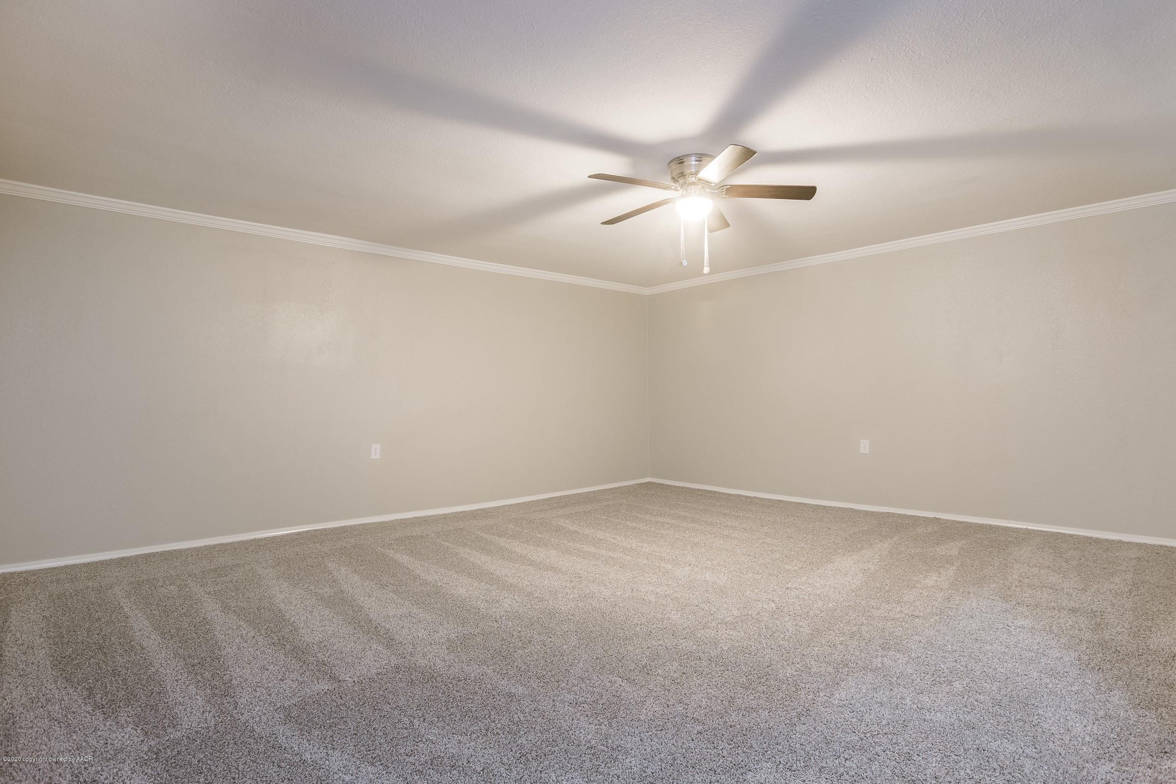 5135 Bowie Street Amarillo, TX 79110 - Photo 12 of 24 an empty room with a ceiling fan and a fan