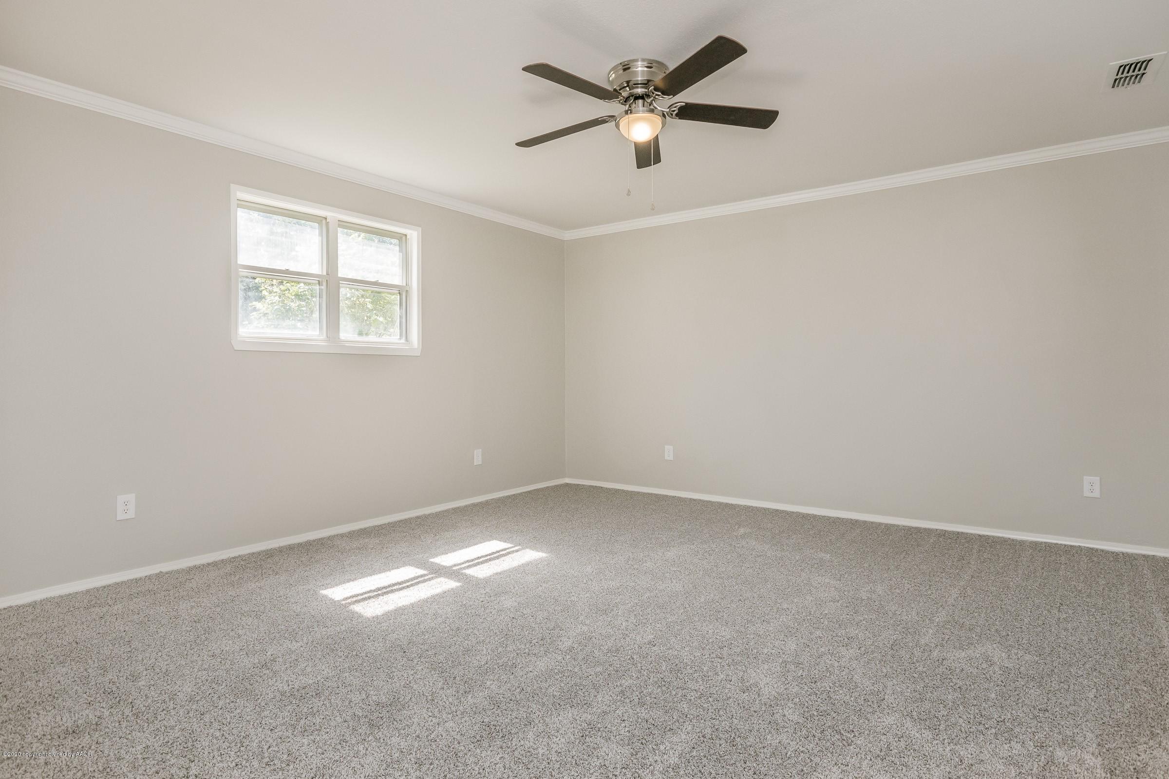 5135 Bowie Street Amarillo, TX 79110 - Photo 13 of 24 an empty room with a window and a fan