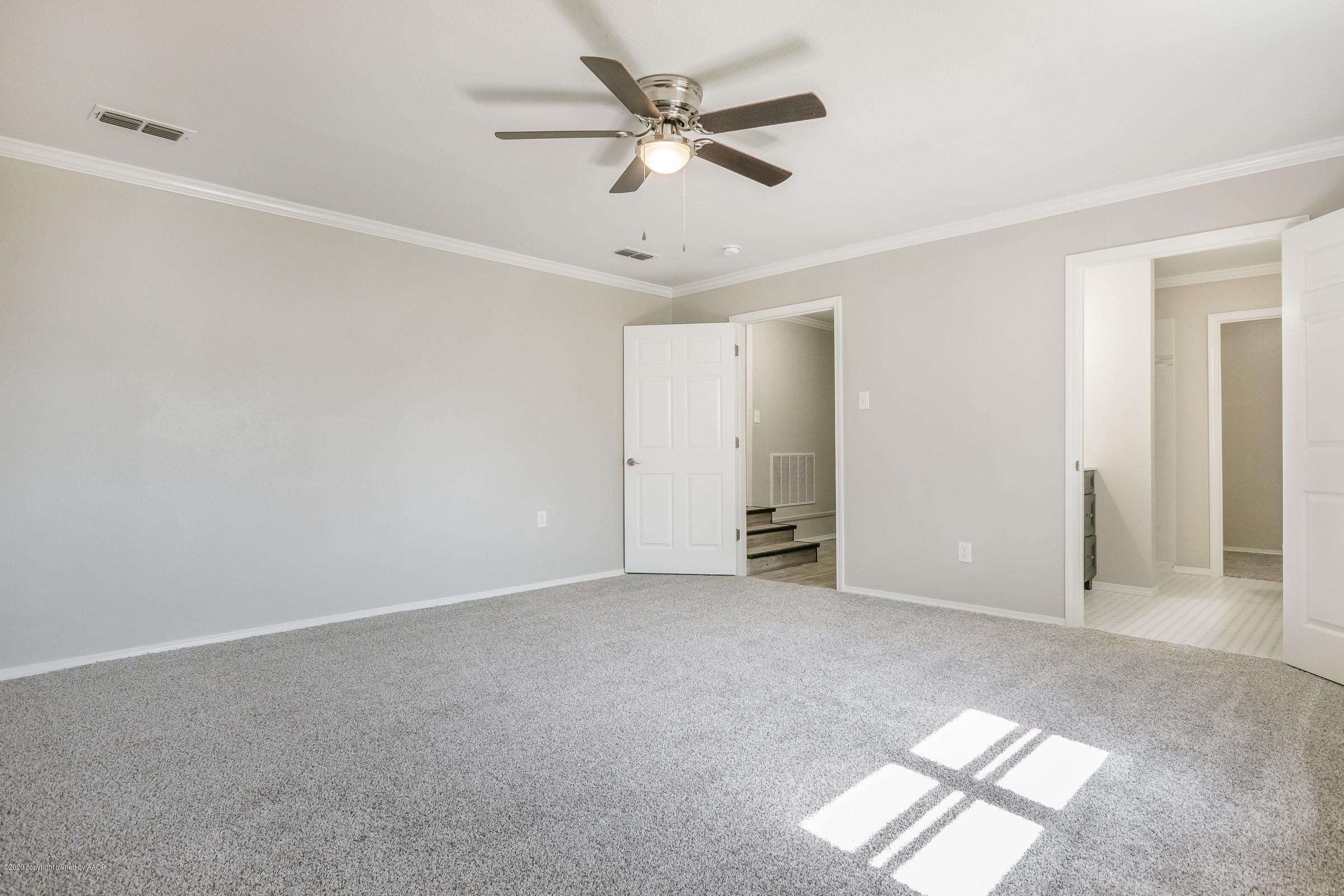5135 Bowie Street Amarillo, TX 79110 - Photo 14 of 24 an empty room with windows and fan