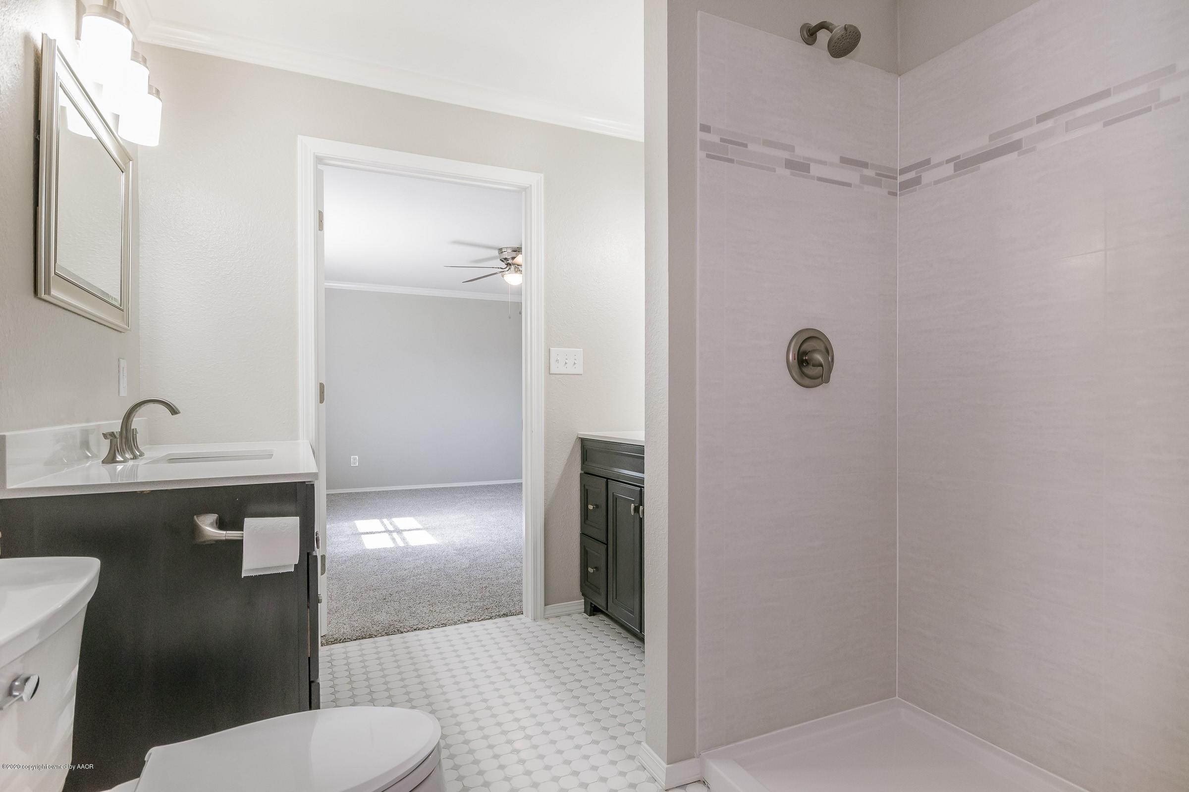 5135 Bowie Street Amarillo, TX 79110 - Photo 16 of 24 a bathroom with a sink a toilet and shower