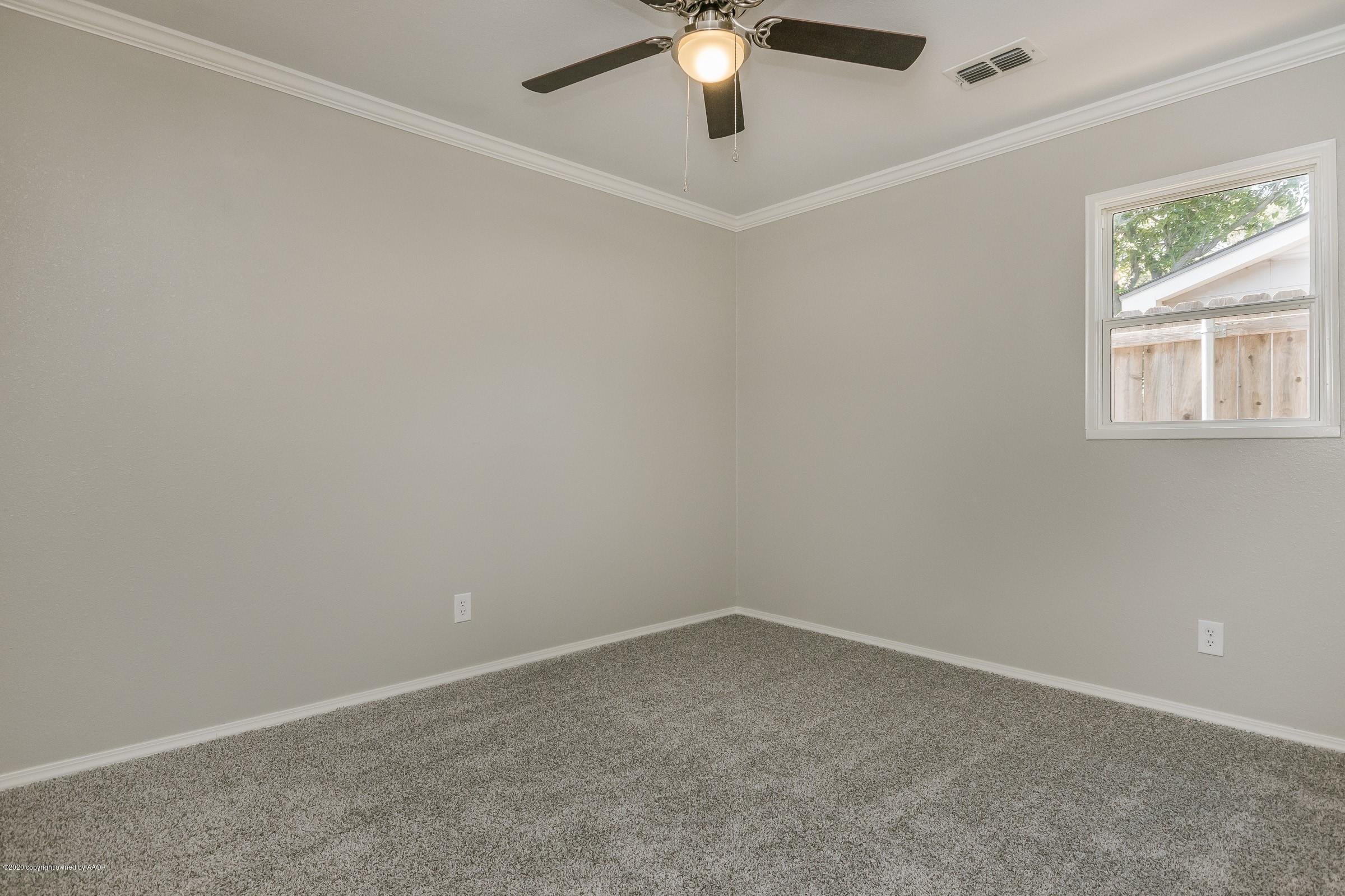 5135 Bowie Street Amarillo, TX 79110 - Photo 18 of 24 an empty room with a window and a fan