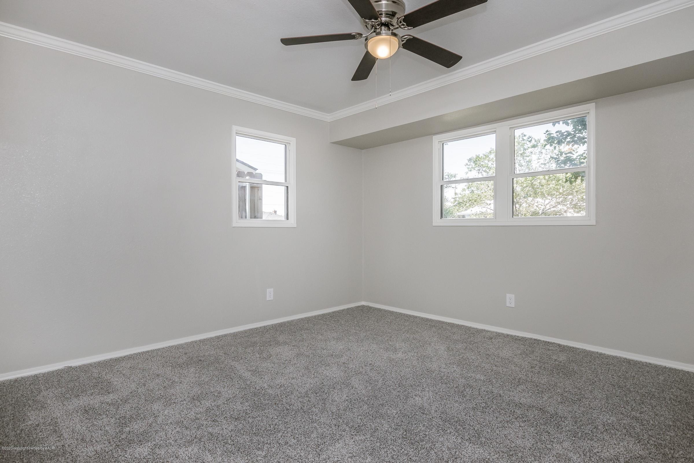 5135 Bowie Street Amarillo, TX 79110 - Photo 20 of 24 an empty room with windows and fan