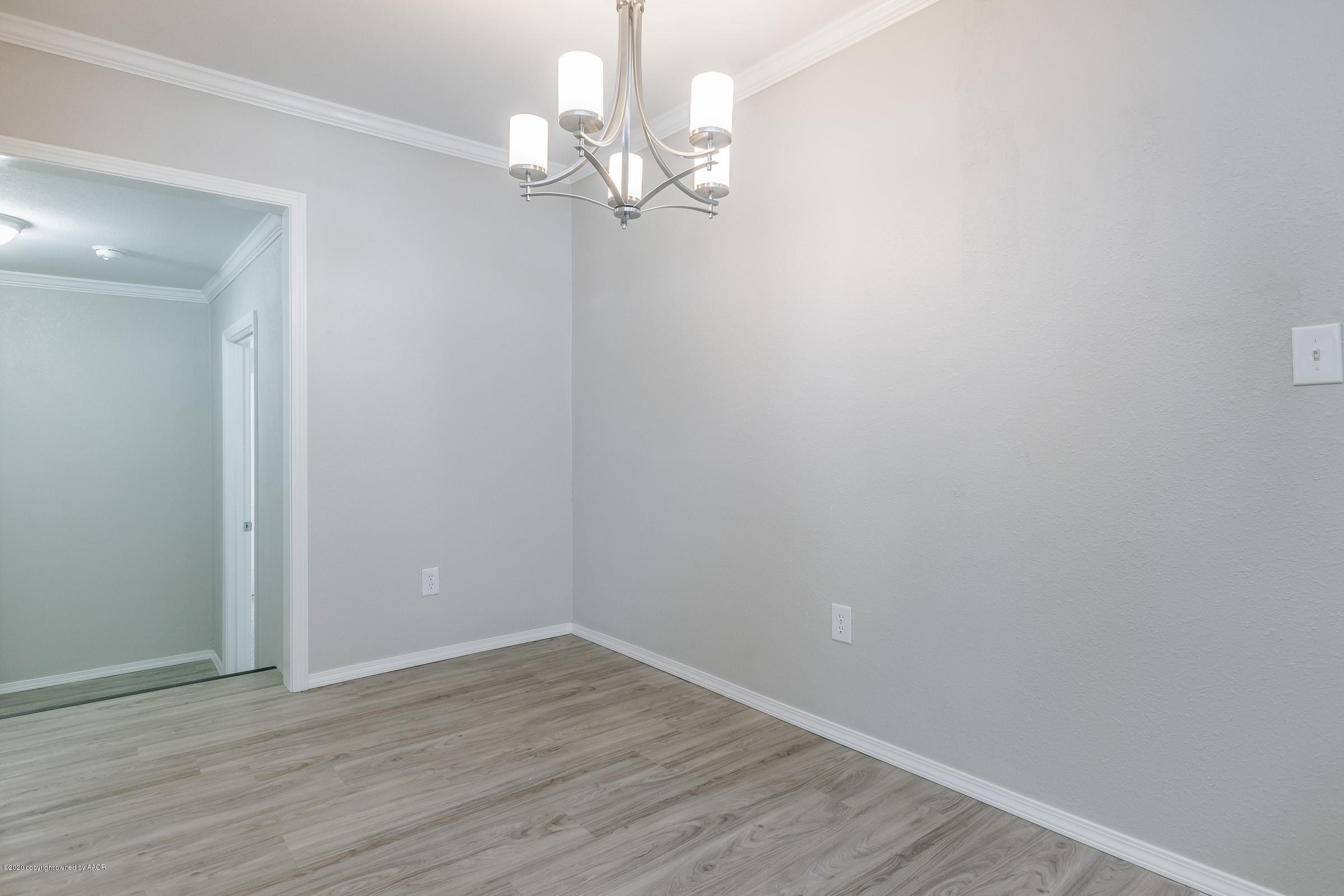 5135 Bowie Street Amarillo, TX 79110 - Photo 4 of 24 a view of an empty room with wooden floor