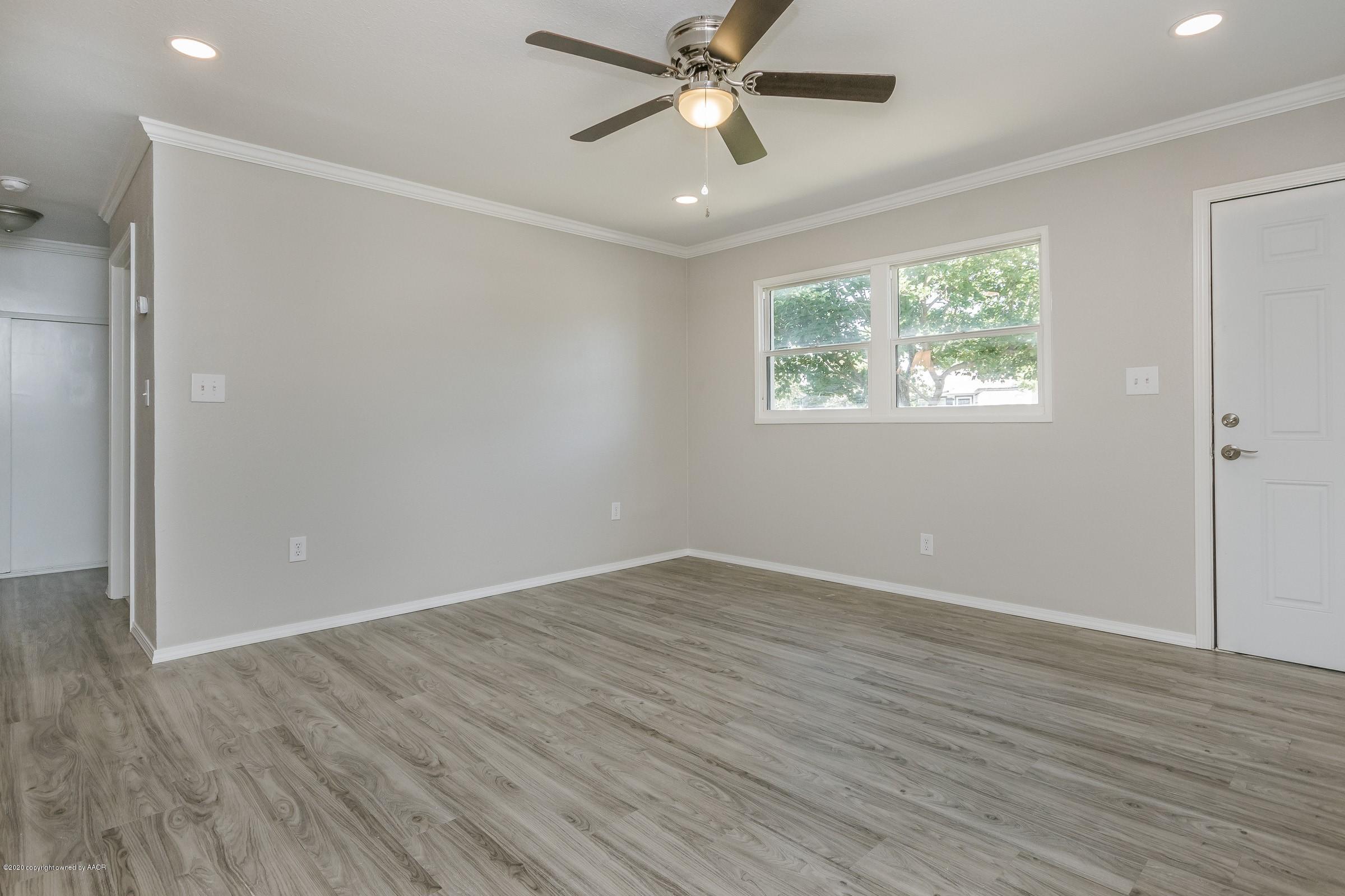 5135 Bowie Street Amarillo, TX 79110 - Photo 6 of 24 wooden floor in an empty room with a window