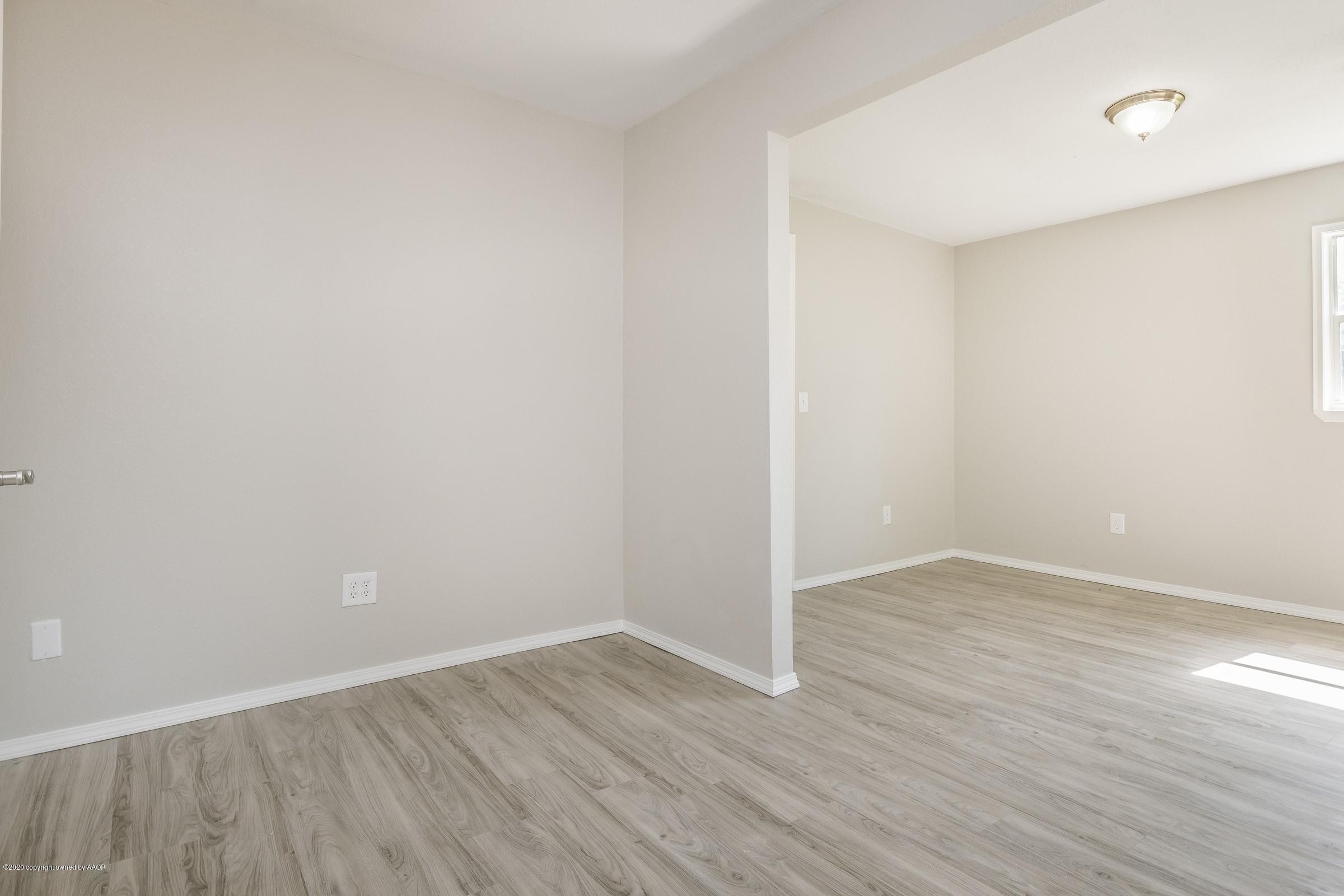 5135 Bowie Street Amarillo, TX 79110 - Photo 10 of 24 a view of an empty room with wooden floor