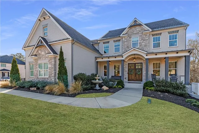 a kitchen with stainless steel appliances granite countertop a kitchen island a stove a table and chairs in it