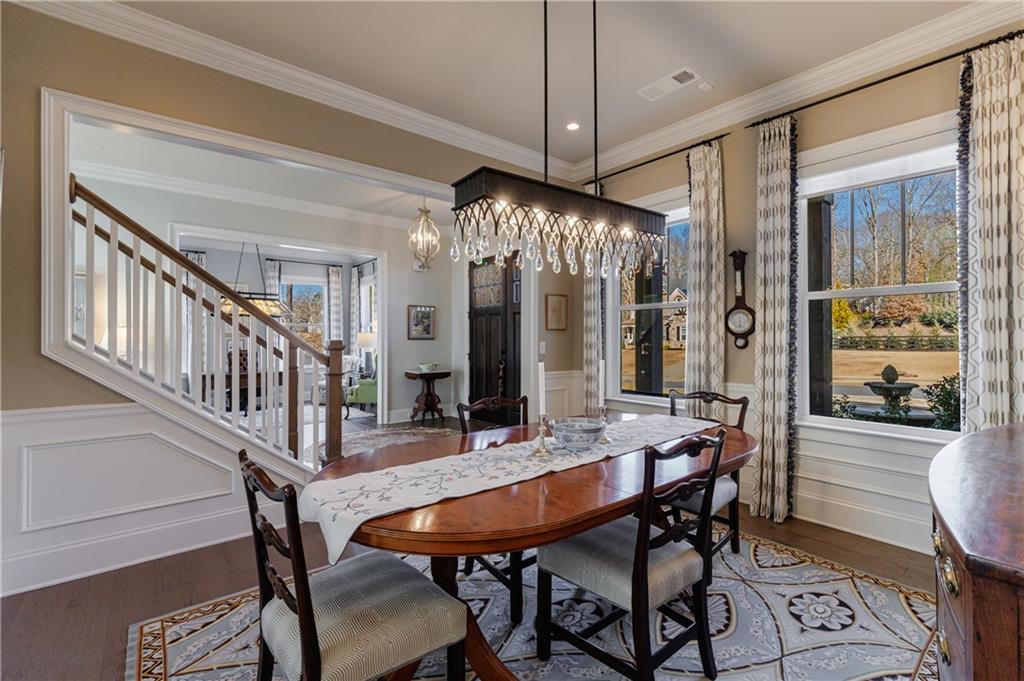 3085 Gray Hawk Lane Roswell, GA 30076 - Photo 11 of 99 a view of a dining room with furniture wooden floor and chandelier