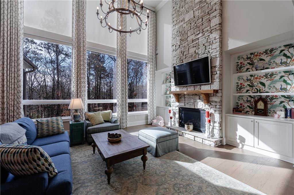 3085 Gray Hawk Lane Roswell, GA 30076 - Photo 26 of 99 a living room with furniture a fireplace and a flat screen tv
